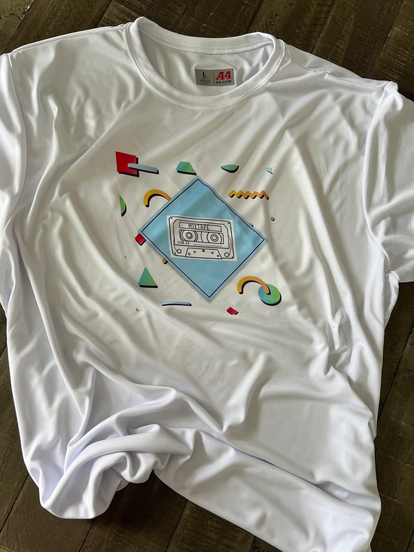 Retro cassette tape design with vibrant geometric shapes, blending nostalgia with modern style. It’s perfect for casual wear. Made with premium fabric, it’s a stylish and versatile statement piece.